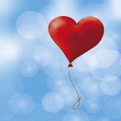 Fototapeta na wymiar Ein roter Herzluftballon schwebt in den Himmel
