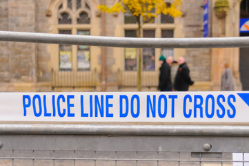 Police line do not cross tape blocking off a road following an incident