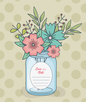 mason jar with floral decorations and save date card