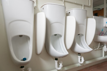 Urinals in an old office building.