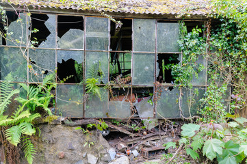 Broken windows at an abandoned workshop