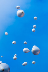 White helium balloons are released into the sky