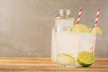 Summer cool drink, lemonade with lime and ice, two glasses with space, summer mood, refreshing drink, freshness