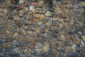 Close-up surface of the old dirty fence made of natural stone and cement