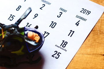 Calendar with toy helicopter as symbol of national armed forces day. 18 May 2019 - Armed Forces Day