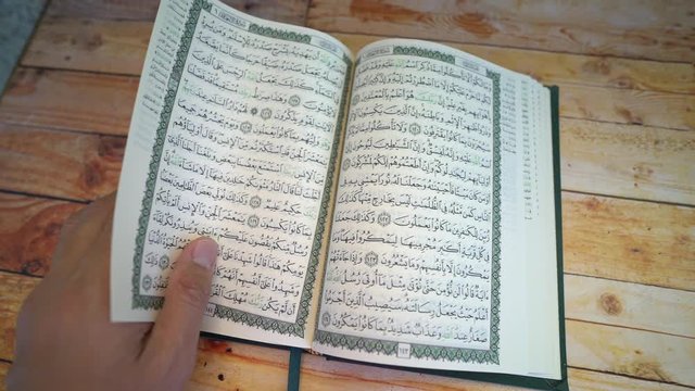 Quran book on wooden table. Islam Ramadan concept. 