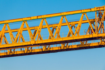 A pair of yellow construction trusses