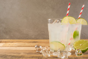 Fototapeta premium Summer cool drink, lemonade with lime and ice, two glasses with space, summer mood, refreshing drink, freshness