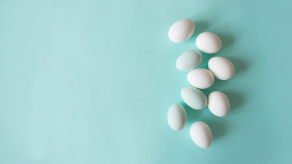 chicken eggs on a blue background bed monochrome shades, place for text, minimalism