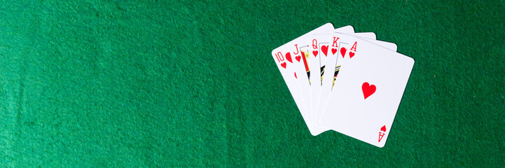 Royal flush of hearts on green background. Winning hands of poker playing cards