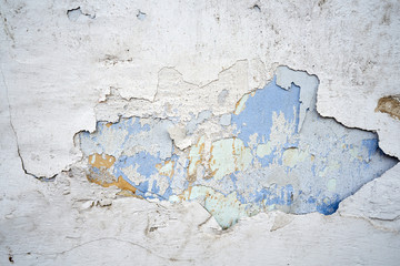 Close-up of old wall with peeling paint surface. Grunge background.