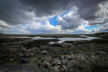 Dramatic view of clouds forming across the marshes on the Kent coastline in England.