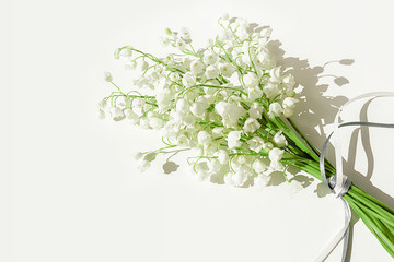 A bouquet of lilies of the valley on a white background. Isolated, selective focus, copy space.