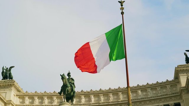 Italian flag waving against the equestrian statue representing the Italian 4k