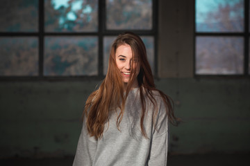 Portrait of cute, redhead teenage girl in gray sweater.