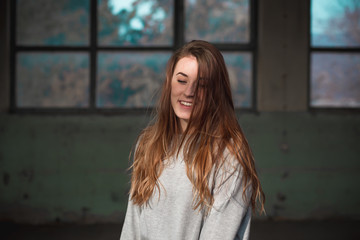 Obraz na płótnie Canvas Portrait of cute, redhead teenage girl in gray sweater.