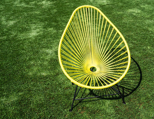 yellow chair on green grass 