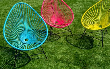 colorful lawn chairs on green grass