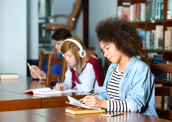 African American student studying in library