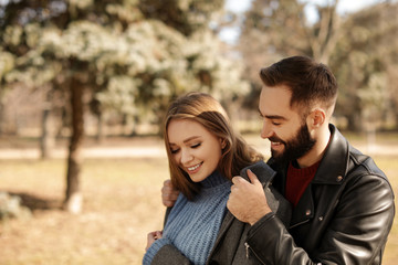 Portrait of cute young couple in park on sunny day