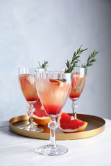 Glasses of grapefruit cocktails on table. Space for text