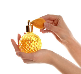 Woman holding bottle of luxury perfume on white background, closeup