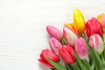 Beautiful tulips and space for text on wooden background, top view. Spring flowers