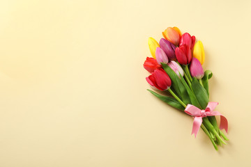 Beautiful bouquet of spring tulip flowers on color background, top view. Space for text