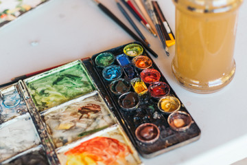 palette with paints and brushes