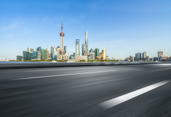 cityscape and skyline of shanghai from empty asphalt road.