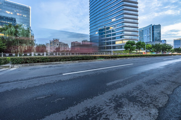 Fototapeta na wymiar city empty traffic road with cityscape in background.