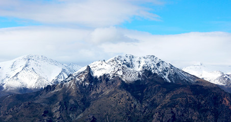 Panorama of snowy mountains and blue sky