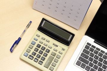 Office desk workplace laptop computer ,calculator and calendar