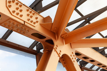 Heavy Beams And Chanals Of Steel Bridge Construction Painted Orange Paint. Metal Framework Of...