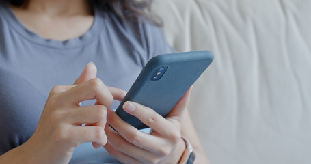 Close up of woman use of mobile phone at home