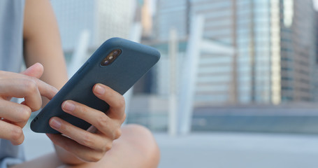 Close up of woman use of mobile phone in city