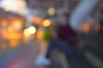 Women are sitting on the edge to wait for the bus,blur image