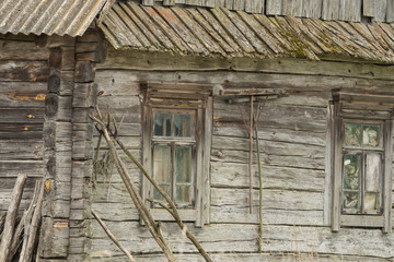 An old wooden house with agricultural tools. Komory village. Polesie. Ukraine.