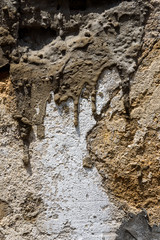 Close up of old weathered masonry wall with cement patches, as a textured background