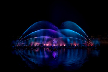Fototapeta na wymiar The colorful fountain dancing in celebration festival with dark night sky background.