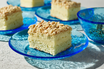 Pieces of peanut biscuit cake on blue plates