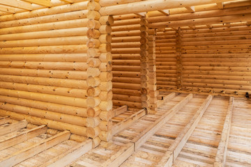 construction of eco-friendly house made of wood. walls, floor and ceiling of the unfinished house from the log. the concept of building a natural eco-friendly house and eco-friendly building material