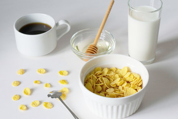 Healthy breakfast with cornflakes and milk over white background