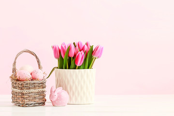 Wicker basket with Easter eggs and ceramic rabbit figure
