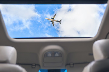 airplane from open hatch of the car during summer vacation. Travel and freedom concept