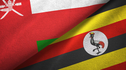 Fototapeta premium Oman and Uganda two flags textile cloth, fabric texture