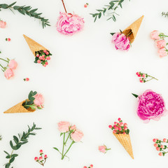 Floral frame with pink peonies, roses petals, eucalyptus, waffle cones on white background. Flat lay