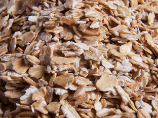 Oat flakes close up angle view textured background