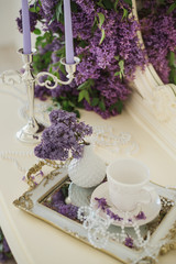 Closeup of lilac floral composition in luxury bedroom interior. Bridal morning decorations