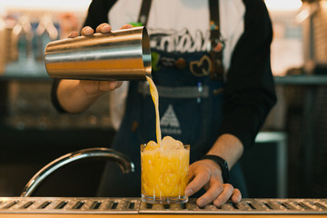 Barman making a cocktail at the bar